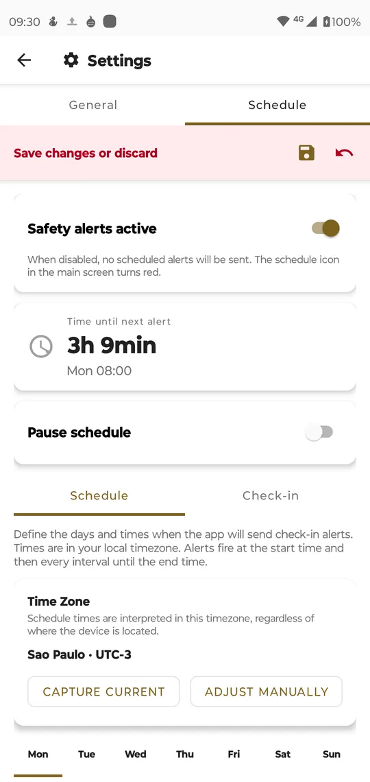 Settings, Schedule: Safety alerts active switched on, time until next alert 3h 9min, Pause schedule, the Schedule sub-tab with the time zone São Paulo UTC-3 and the days of the week, and the pink Save changes or discard bar